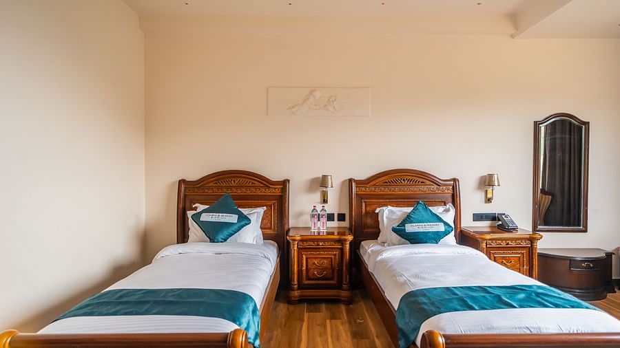 an image of a bedroom with a mirror next to it.